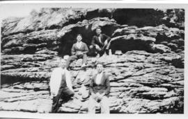 Four men sitting on rock krantz. (Lund collection)