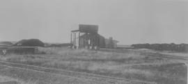 Vryburg, 1895. Water tank with locomotive shed behind. (EH Short)