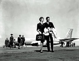 
SAA Boeing 707 ZS-CKD. Passengers walking away from aircraft.
