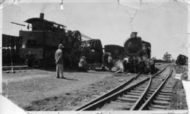 Crane truck and steam locomotive at station. (Lund collection)