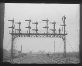 Signal gantry spanning rail lines.