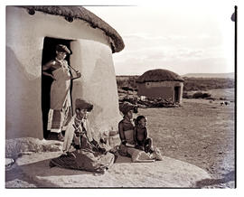 Transkei, 1952. Three Xhosa women with baby at hut.