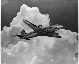 Circa 1948. Model of SAA Douglas DC-4 Skymaster ZS-AUA 'Tafelberg' on cloud background.