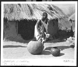 Northern Transvaal, 1934. Sesotho woman with ladles at beer pots.