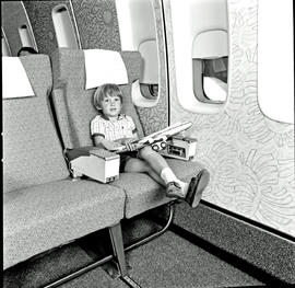 
SAA Boeing 747 interior. Boy with 747 model.
