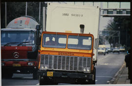Container on SAR Oshkosh truck on city street.