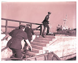 Durban, July 1974. Water police charging up steps in Durban Harbour.