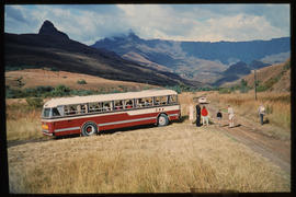 Drakensberg, 1975. SAR Leyland Olympic tour bus with passengers at roadside stop with Amphitheatr...