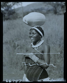 Zululand, 1956. Zulu woman with pumpkin on head.