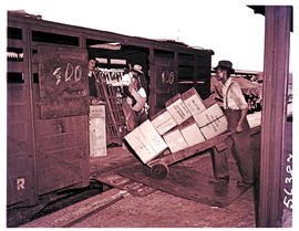 Cape Town, 1950. Loading boxes onto SAR railway wagon in railways goods yard.