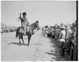 Basutoland, 11 March 1947. Tribal leader on horseback keeping stick-wielding troop behind the lin...