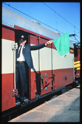 Conductor indicating readiness to go.