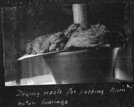 Circa 1925. Drying waste for packing main motor bearing. (Album on Natal electrification)