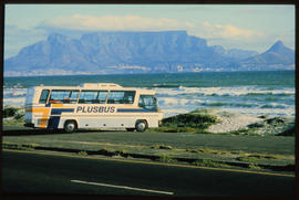 Cape Town, circa 1980s. SAR Neoplan Jetliner PLUSBUS tour bus with Table Mountain in the distance.