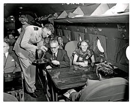 
SAA Douglas DC-4 interior filled with passengers. Steward.
