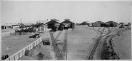 Kimberley, 1895. Station looking north with row of animal-drawn carts on street side of station b...