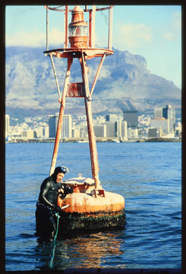 Cape Town, 1987. Diver at light buoy in Table Bay Harbour.