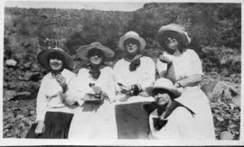 Five women posing.