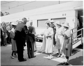 
Queen Elizabeth and the Princesses Elizabeth and Margaret greeted on arriving at a station.
