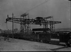 Johannesburg. Kazerne (old location) Train under overhead electric travelling crane loading timbe...