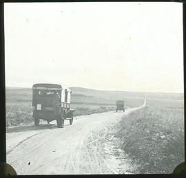 Trucks on gravel road.