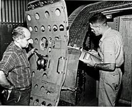 
SAA Boeing 707, technicians inspecting door.

