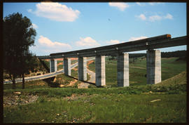 
Passenger train on concrete bridge.
