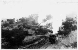 Estcourt, circa 1909. A train hauled by a NGR 'Reid Tenwheeler' assisted by a pair of NGR 'Dubs B...