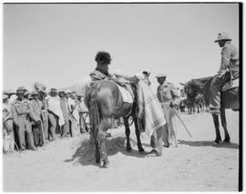 Basutoland, 11 March 1947. Tribal leader about to mount his horse. Another mounted official (guar...