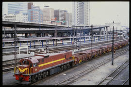 Port Elizabeth, August 1985. SAR Class 34-000 with empty ore wagons at main railway station. [D D...