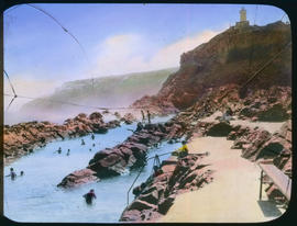Mossel Bay. Rock pool with Cape St Blaize lighthouse in the distance.