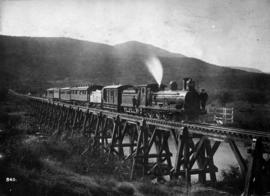 Inciba, circa 1902. CGR 5th Class with passenger train on wooden trestle bridge.