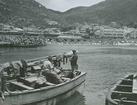 Cape Town, 1940. Fishing boat, bathing beach and train at Kalk Bay.