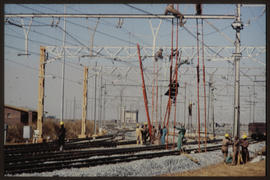 Bapsfontein, August 1982. Erection of catenary cables at Sentrarand marshalling yard. [T Robberts]