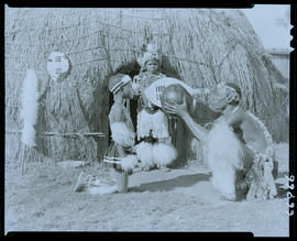 Zululand, 1957. Zulu man drinking from calabash with two children looking on.
