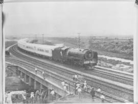 
Spectators on railway lines greet the Royal Train, hauled by SAR Class 15F.

