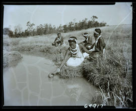Zululand, 1961. Zulu women filling water pots from a stream.