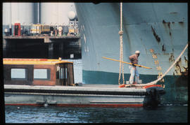 Durban 1978. Small boat alongside big ship in Durban Harbour.