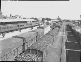 "Kroonstad, 1940. Coal train alongside passenger train in station."