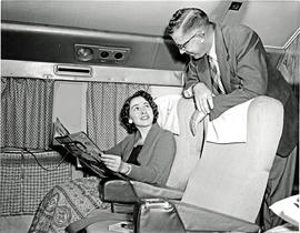 
SAA Douglas DC-7B interior. Passenger reading.
