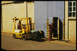 
Forklift transporting two drums.
