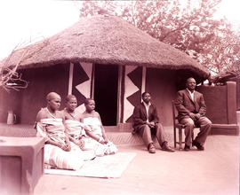 "Louis Trichardt district, 1960. Bavenda Chieftain on chair before hut."