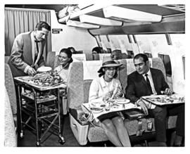 
SAA Boeing 707 interior. Cabin service. Steward. Lobster.
