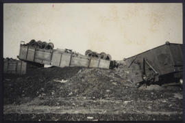 Overturned and derailed train wagons.