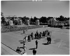Bulawayo, Southern Rhodesia, 15 April 1947. Royal family and dignitaries walk across the field to...