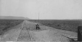 Perdevlei, 1895. Railway lines with railwayman sitting at points. (EH Short)