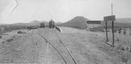 Tweedside, 1895. Train with steam locomotive in the distance. (EH Short)