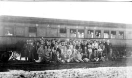 
Tour group posing with train. Photographs taken during Round-in-Nine tour.
