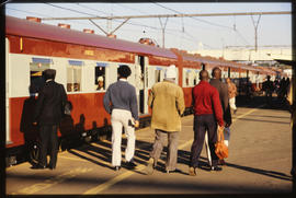 Passengers boarding train at station.