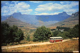 Drakensberg, 1984. SAR Mercedes Benz tour bus with Amphitheatre in the distance.